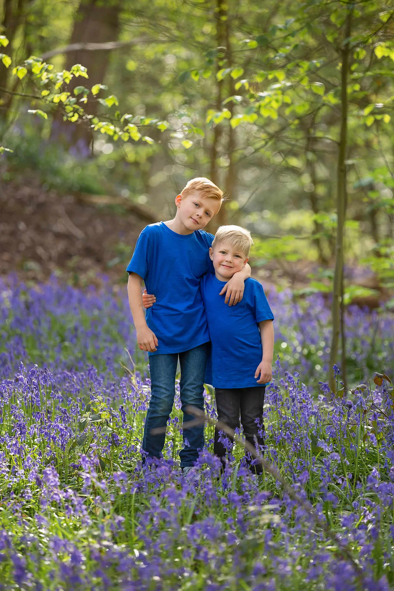 Children photographer Leeds, York, Harrogare, Bradford: brothers posing for a photo during bluebell session in Leeds, West Yorkshire