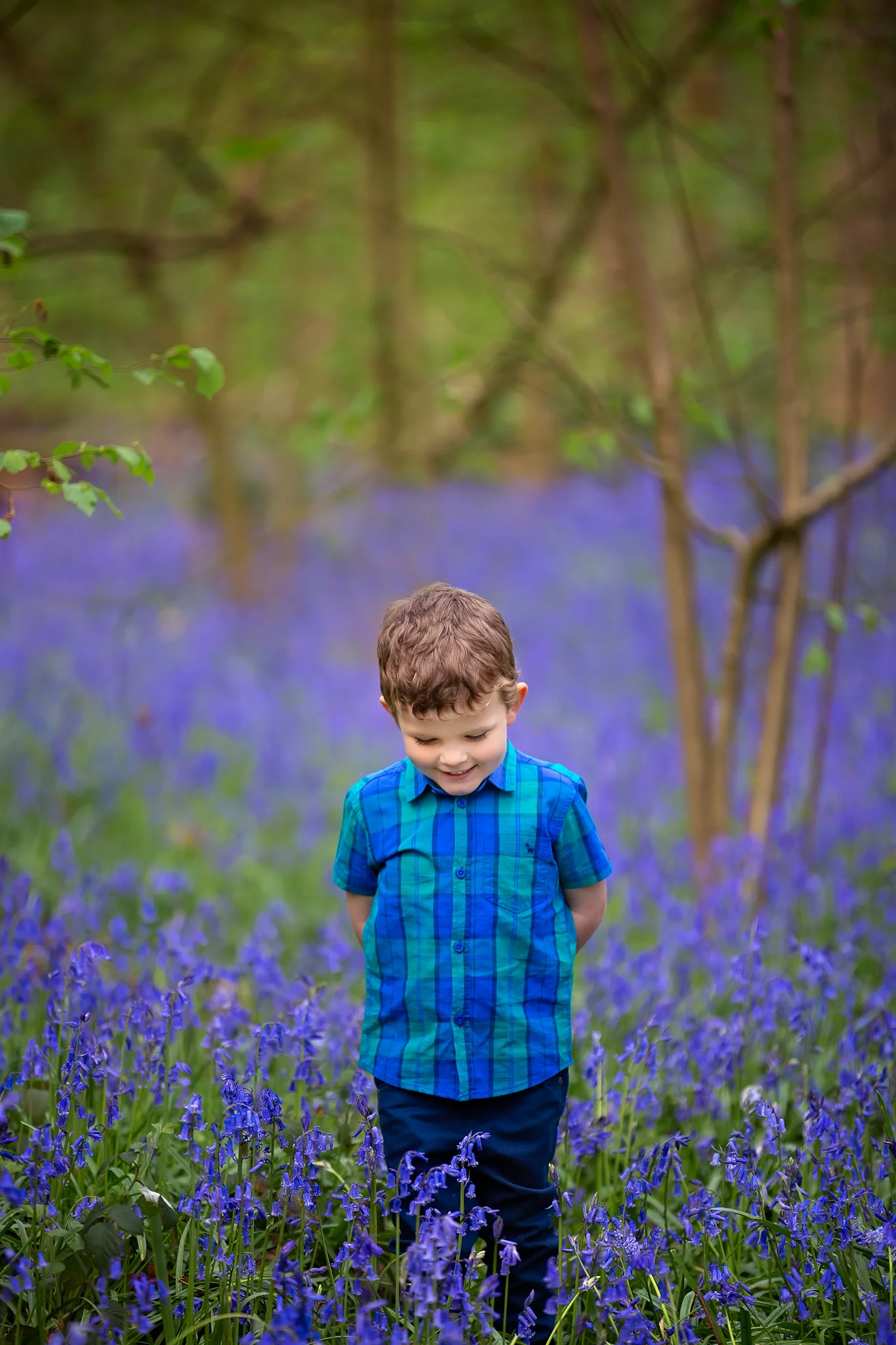 Child photography Leeds, York, Harrogare, Bradford: cute little boy walking though a bluebell wood