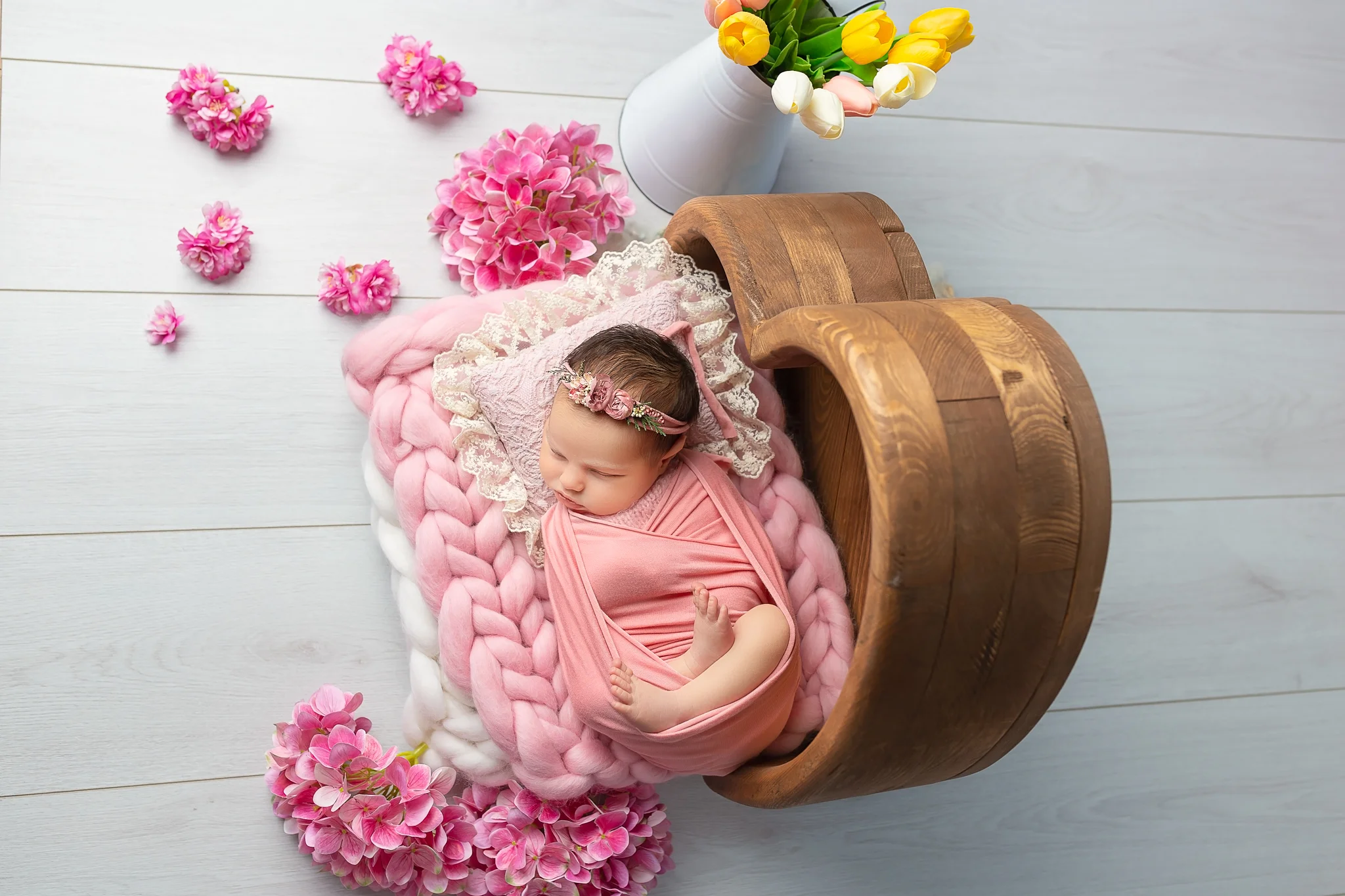 Newborn photography Leeds-York-Harrogate-Wakefield-Bradford: newborn baby girl in pink wrap during her newborn session in Leeds, Yorkshire