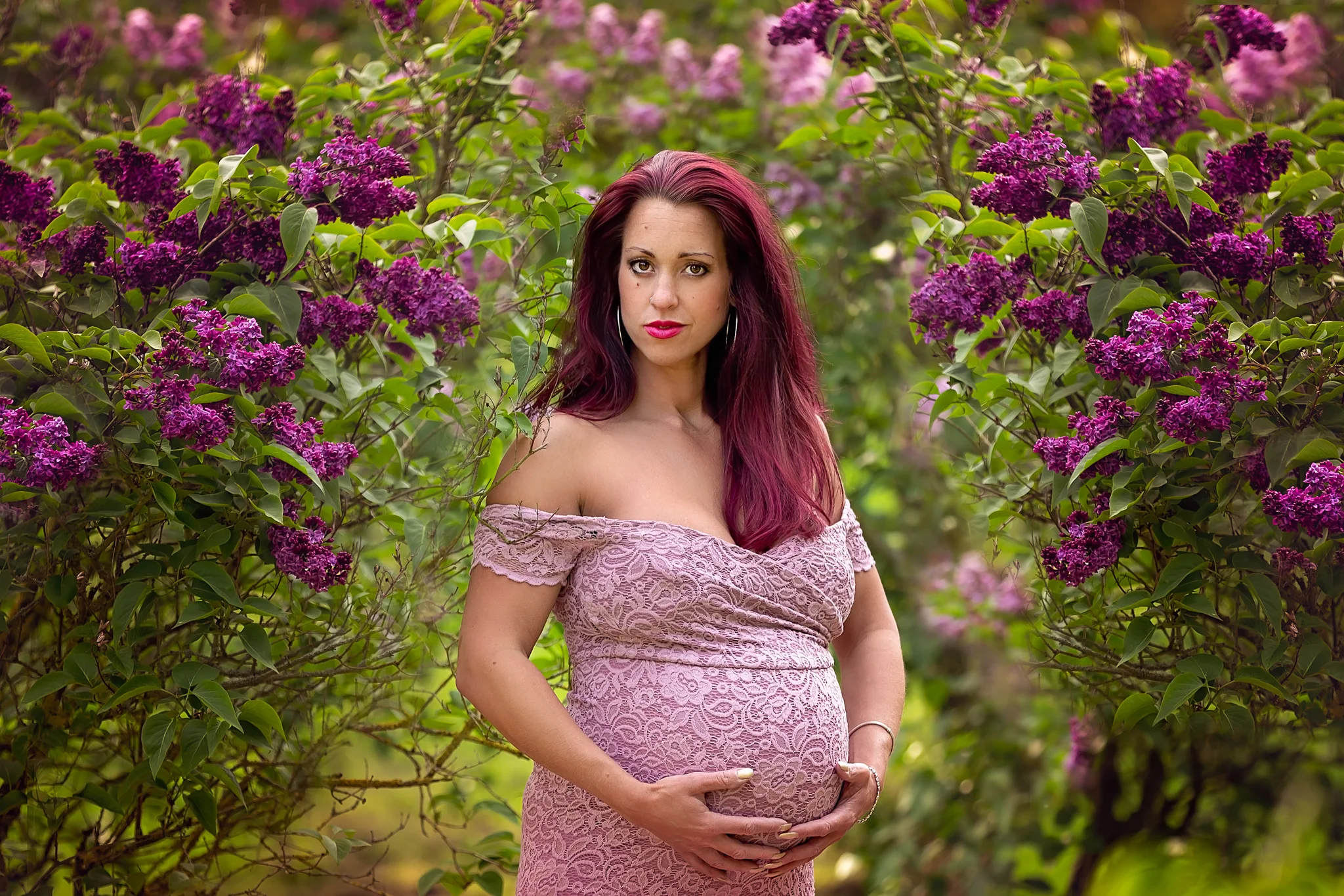 Maternity photographer Leeds-York-Harrogate-Bradford-Wakefield: beautiful pregnant woman in a stunning pink dress surrounded by lilac flowers