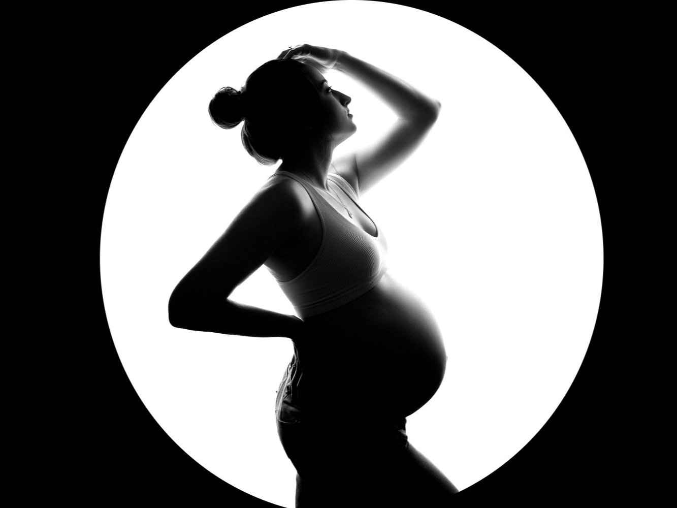 Black&amp;White backlit nude silhouette portrait of a pregnant lady wearing a sheer veil during her maternity photoshoot in Leeds, Yorkshire