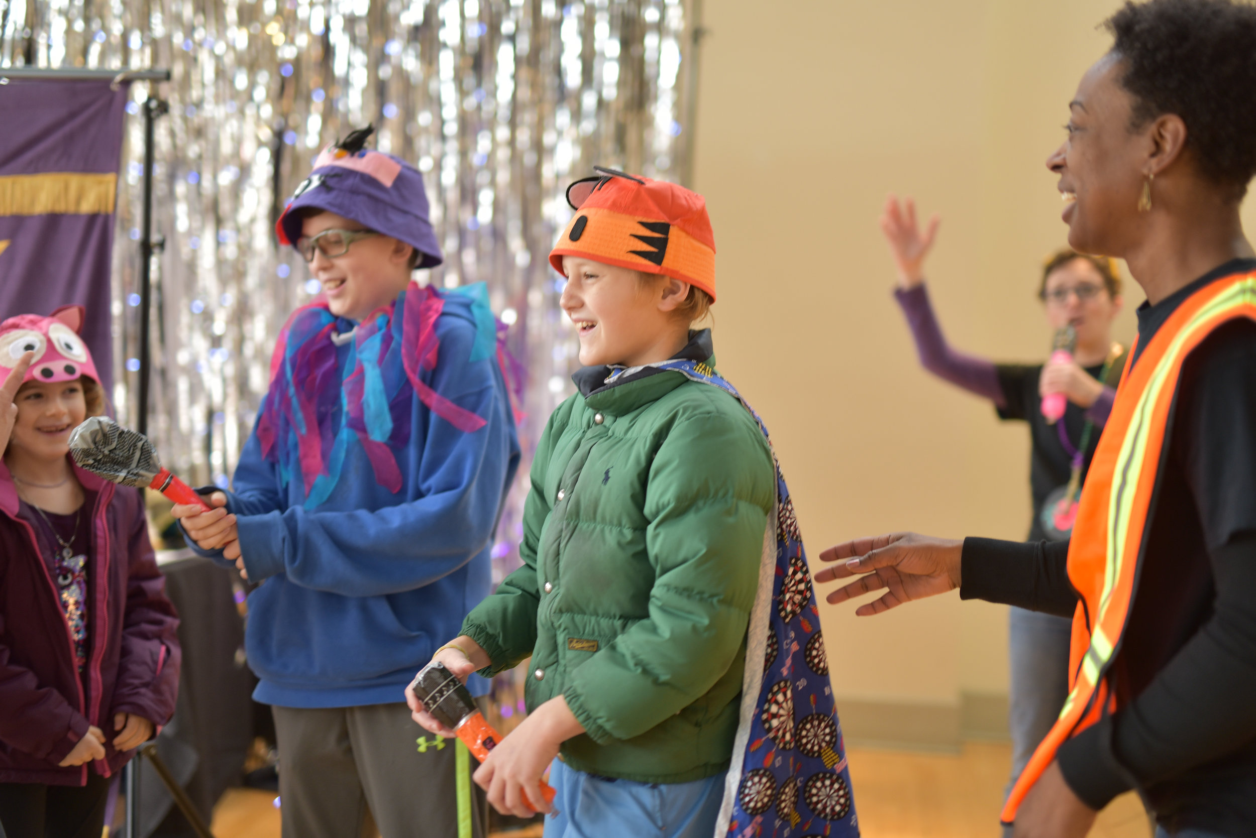 Children and actor playing during children's theatre performance