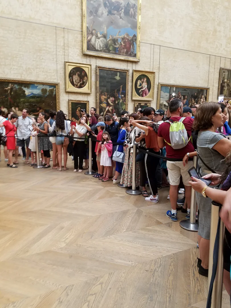Aaaand everyone trying to take a picture of or with “Mona Lisa”