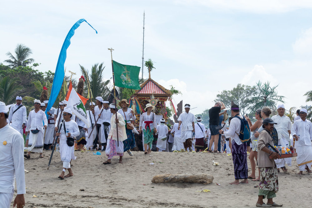 A temple's community making their way to the ocean for purification