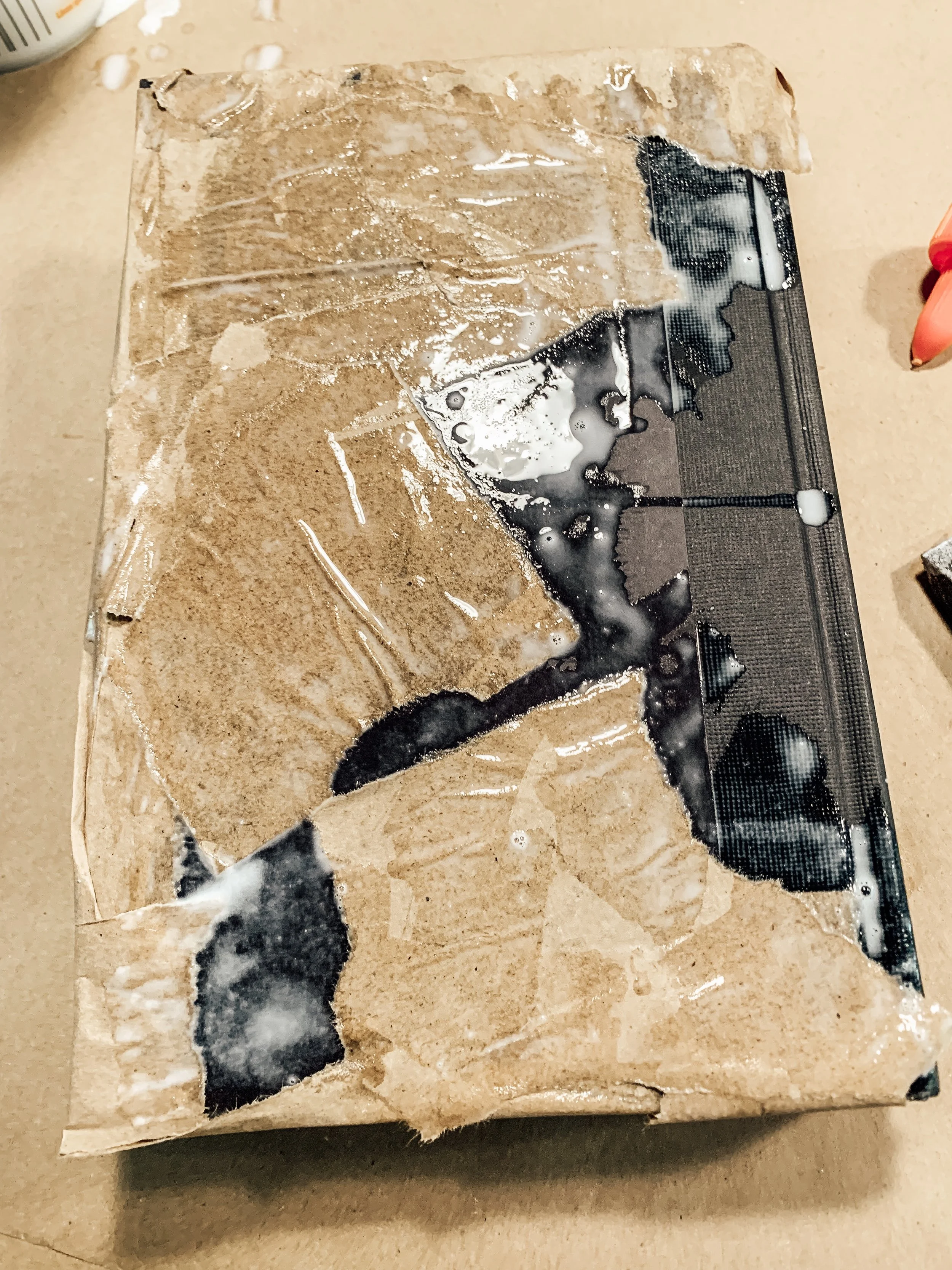 Tear up pieces of bag and cover with glue water mixture, using sponge to smooth it