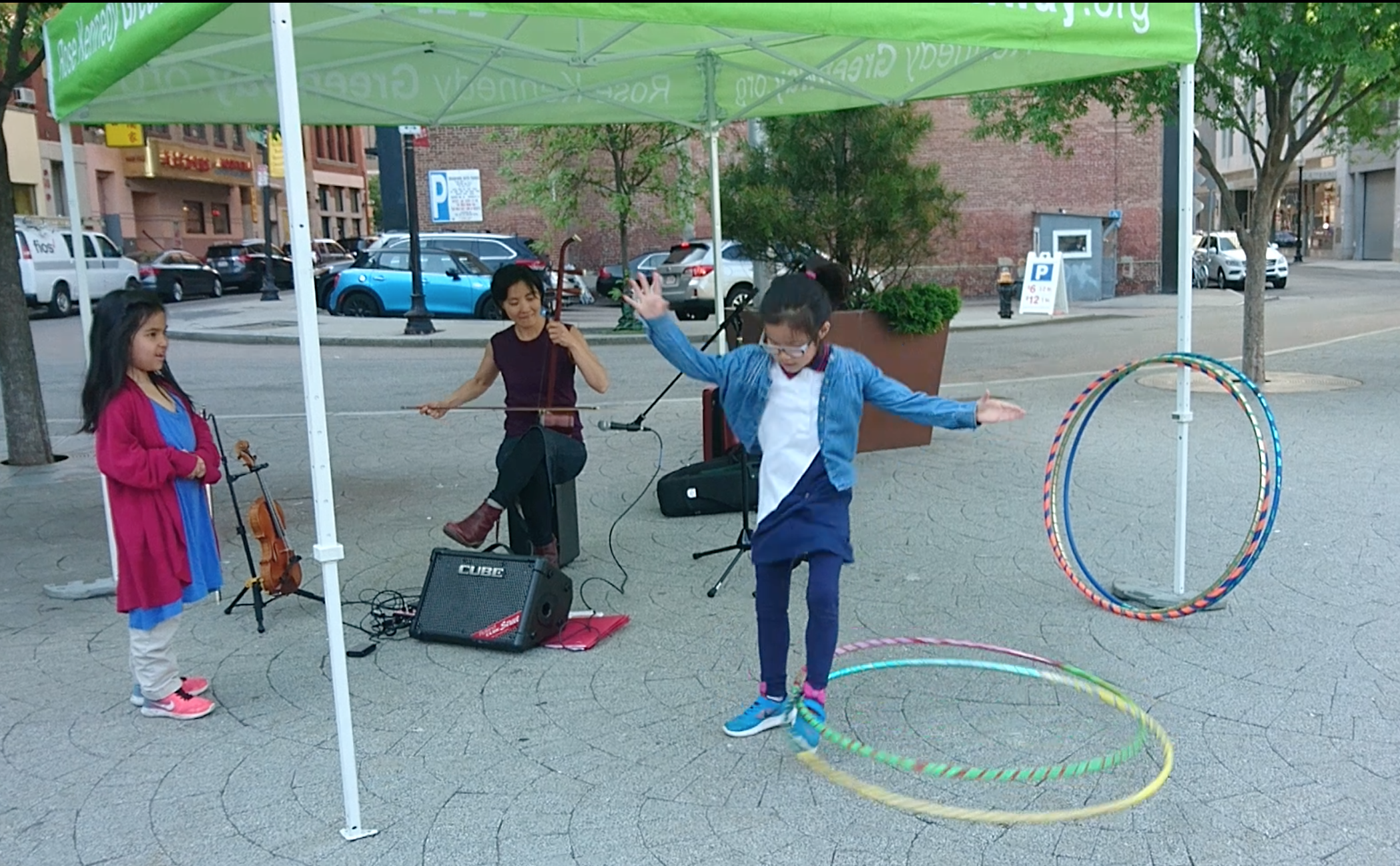 Probable world premiere of erhu racing horses and hula hoop duet! International Song Exchange at the Chinatown Gate/ Greenway park