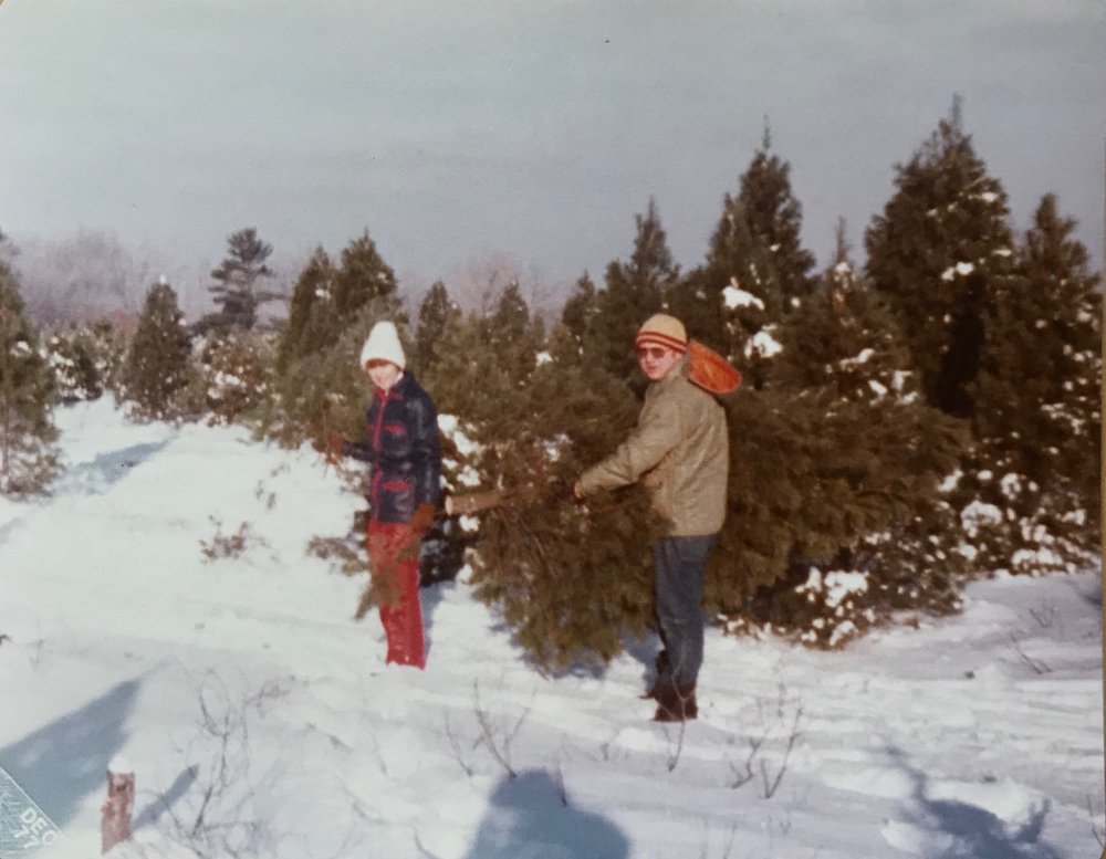My parents cutting our Christmas tree, possibly 1976?