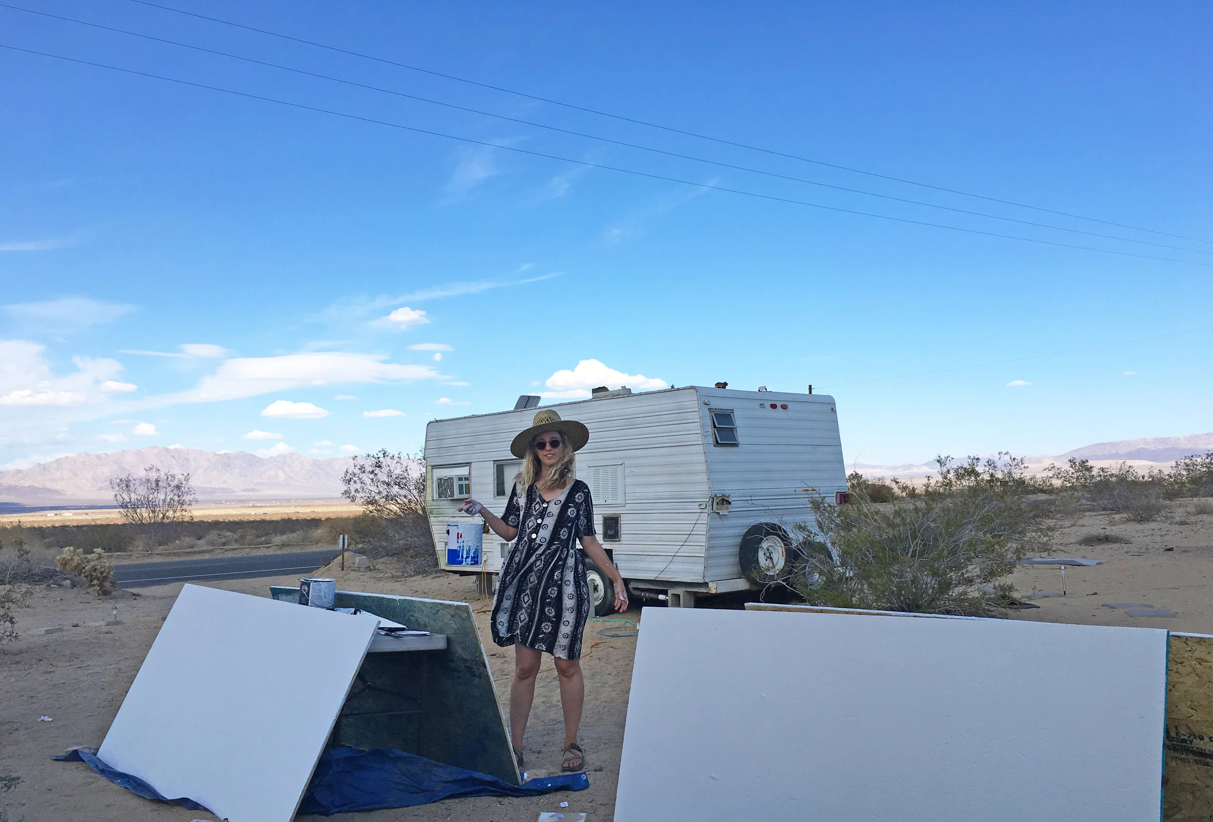 Katie Williams priming some wood on Highway 62, the main road through Joshua Tree, Twentynine Palms and Wonder Valley.