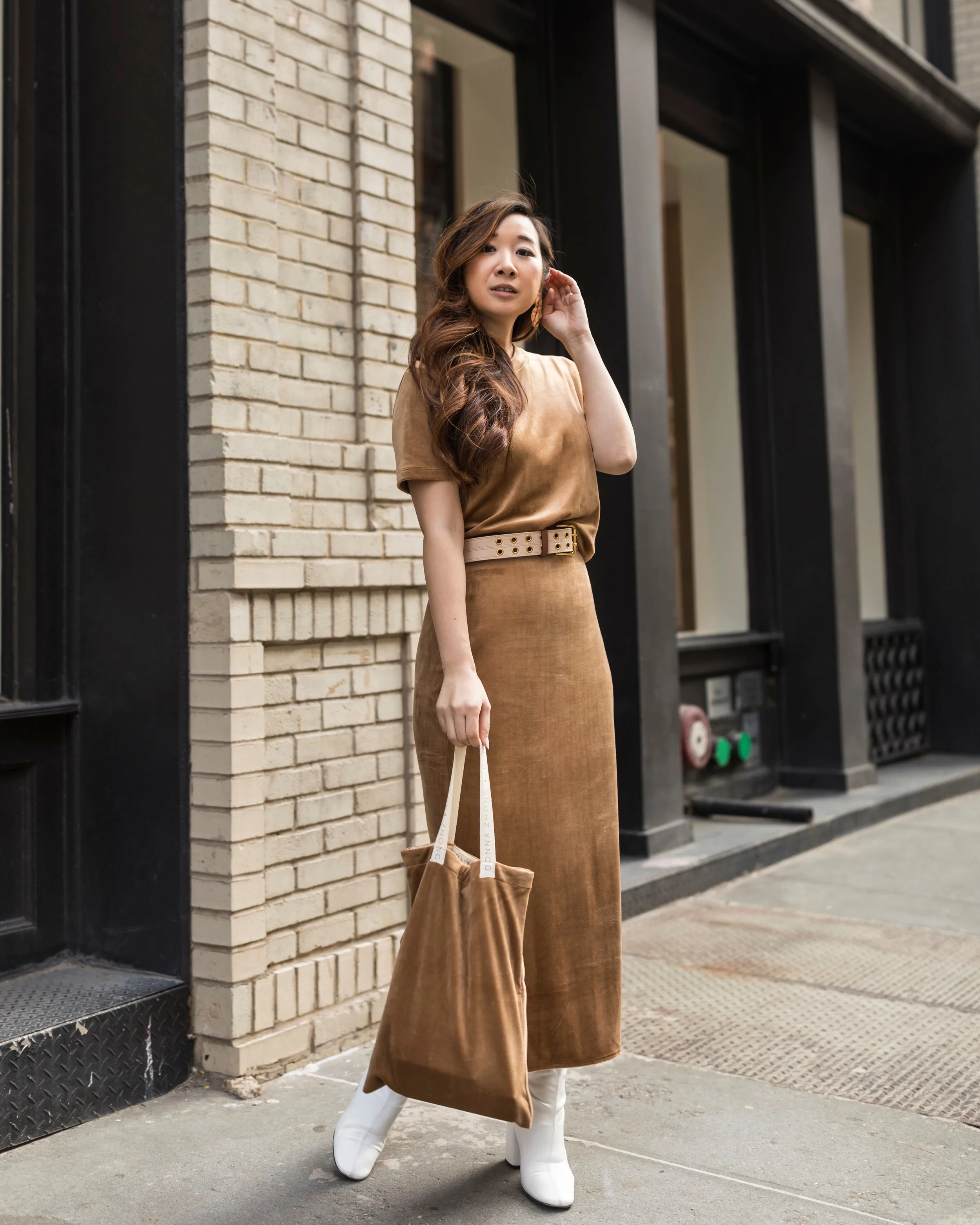 Our #bosslady Tricia Chen, @happilyeverstyle , wearing a Donna Zhong Official matching camel top and skirt while holding one of the velvet goodies bags made by Donna!