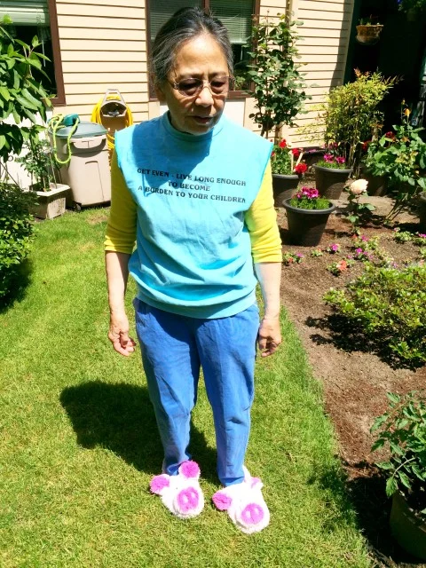 Photo: By Alysha - My melodramatic mother in her pink piggy slippers and slogan shirt. 