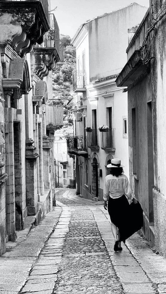 Woman in Hat on Quiet Roams Quiet Sicilian Street.jpeg