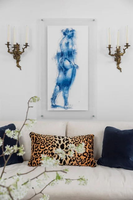 Take for instance, this Chattanooga client’s living room. We combined these ornate Rococo candle sconces from her collection with a modern drawing that we put in a clean lined glass frame. Opposites truly attract!