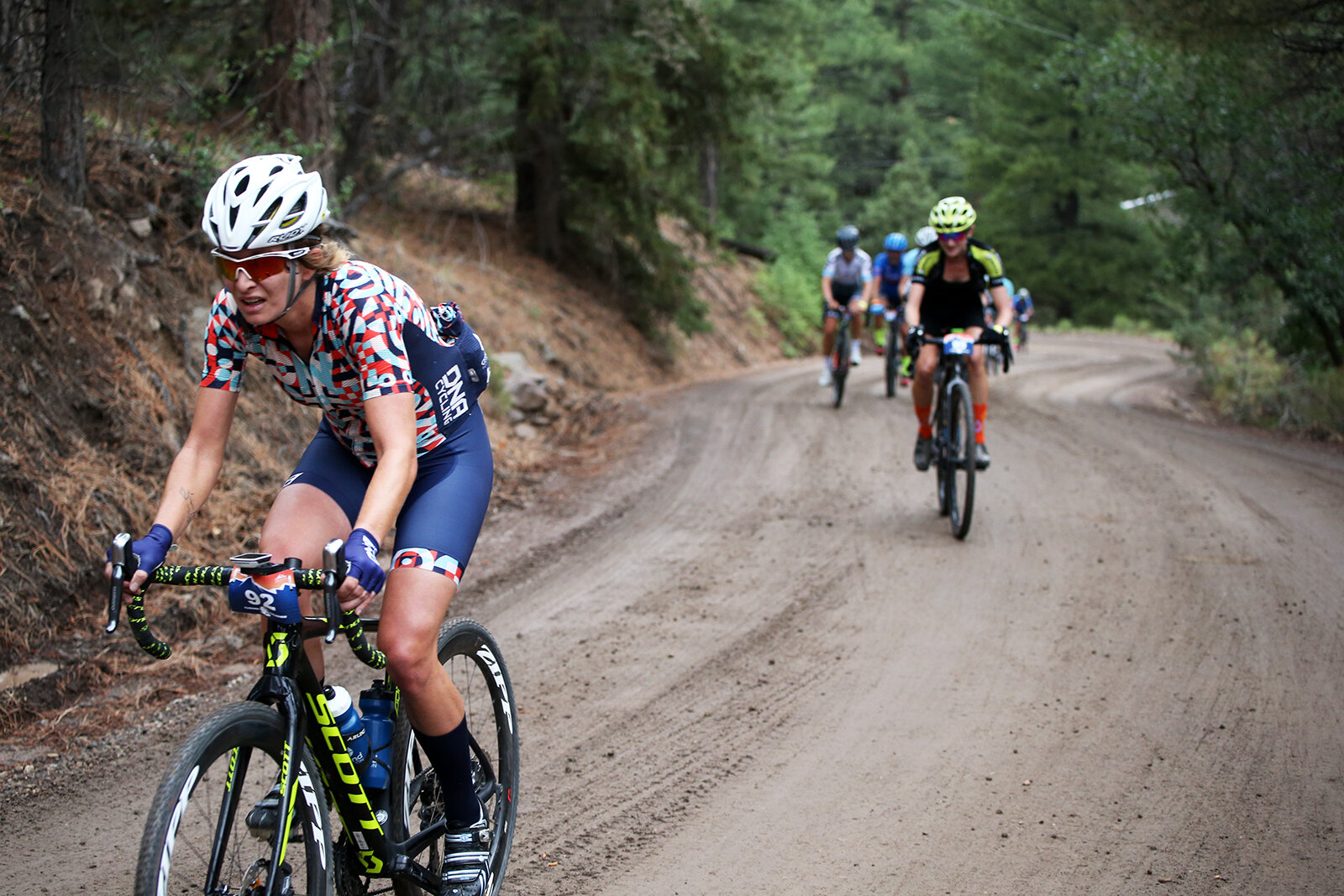  Lauren De Crescenzo attacks as soon as the peloton hits the dirt.  