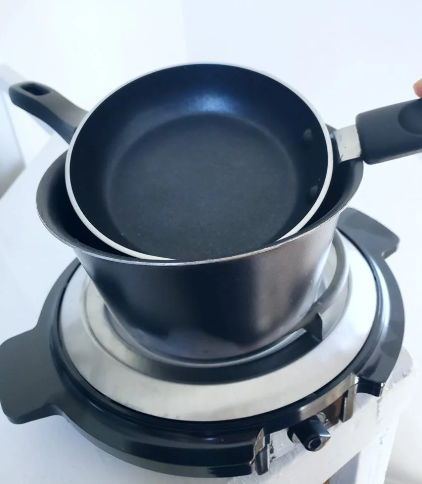 Kristen’s personal setup. A small fry pan, over a small saucepan, on an electric burner.