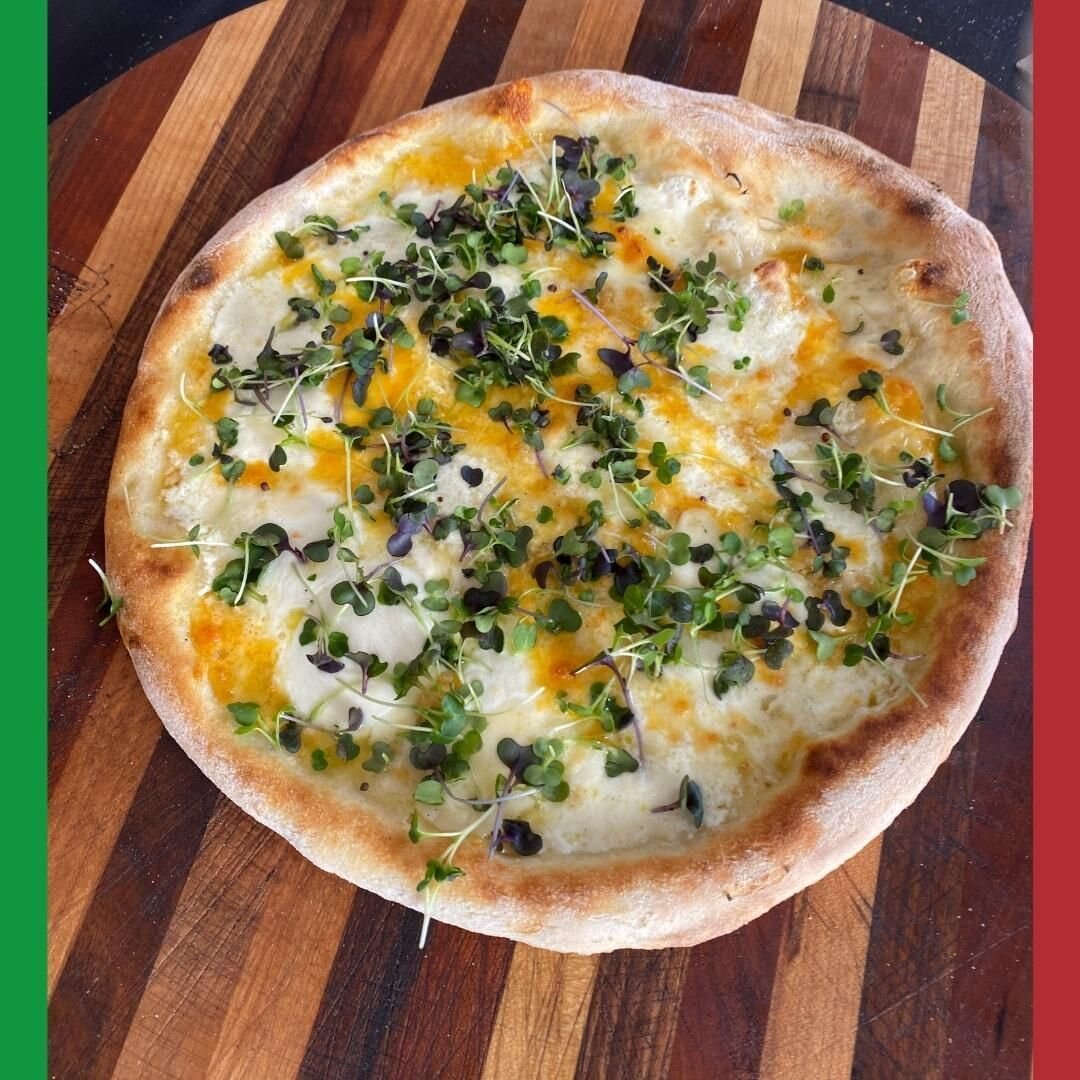 Microgreens add a pop to a quattro formaggi pie. It is so much fun experimenting with ingredients once your BGE airflow is controlled and pizza cooks the same every time with Pizza-Porta. #shutthefrontdoor #cookgreatpizzaathome #pizzaporta