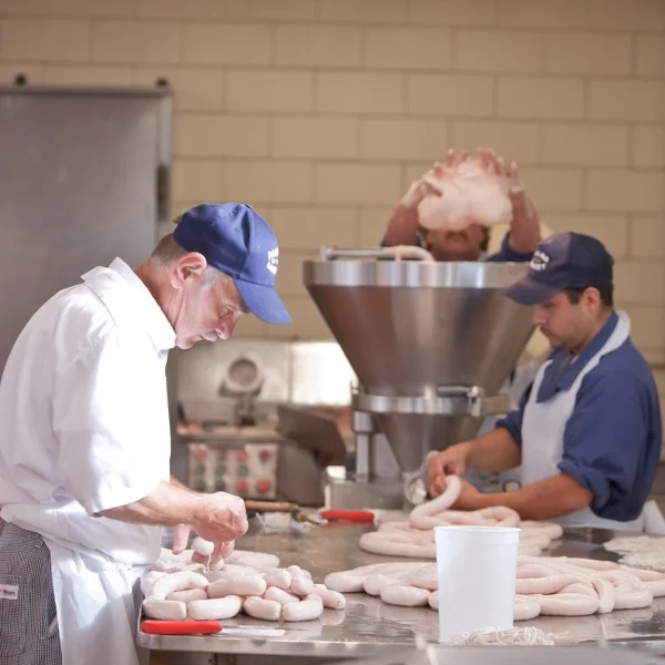 Owner Bill Begale (left) makes sausages at Paulina Market. | Photo via Instagram