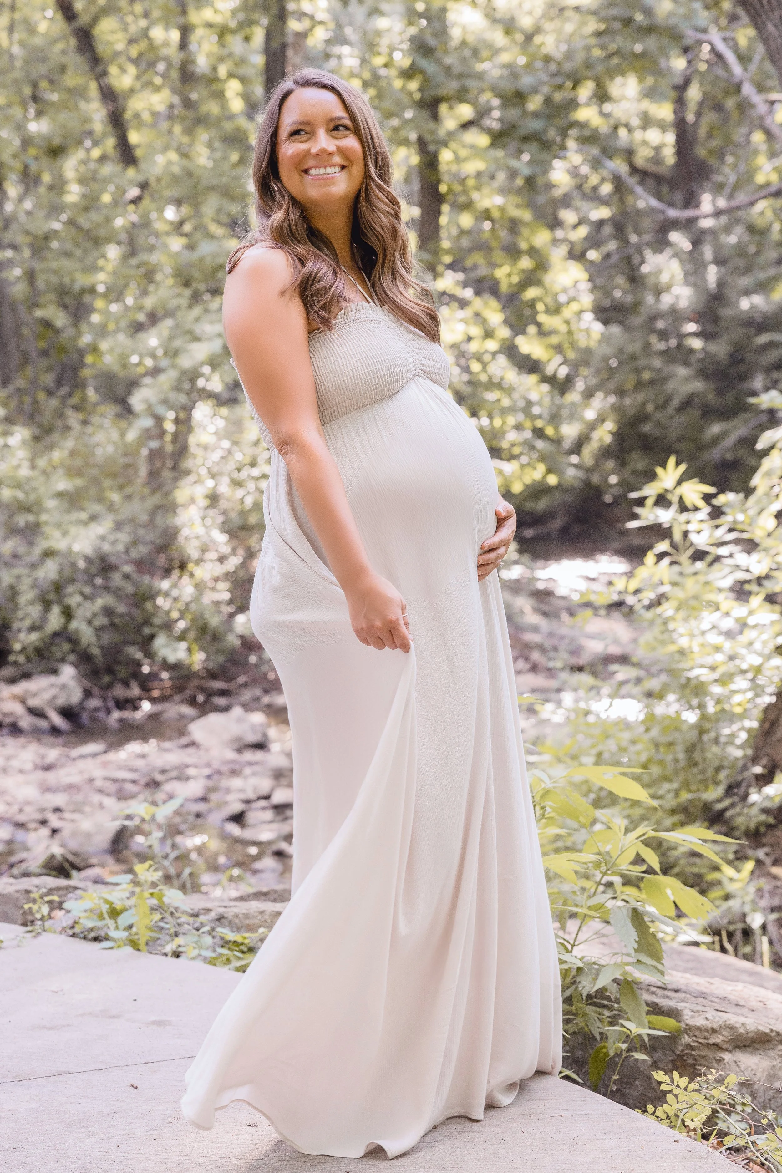 Maternity portraits at Shawnee Mission Park, expecting mother in neutral gown standing in tall grass