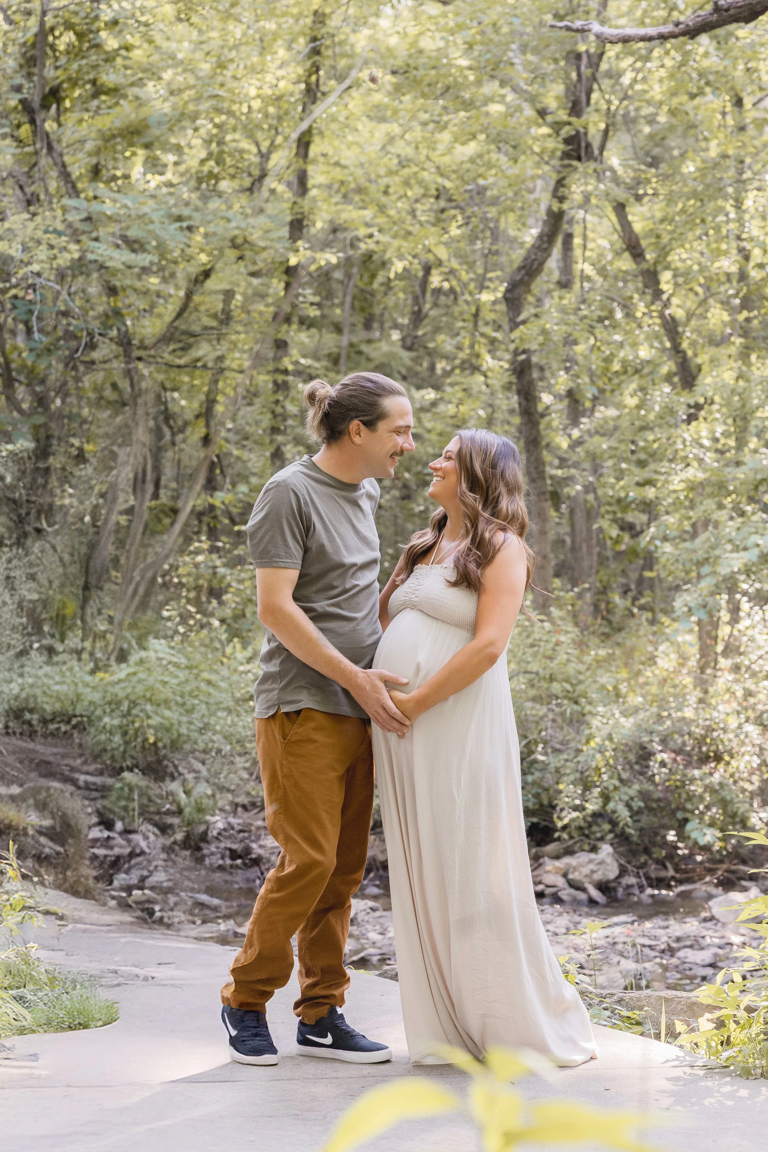 Kansas City maternity portraits, expecting couple looking at each other during summer sunset