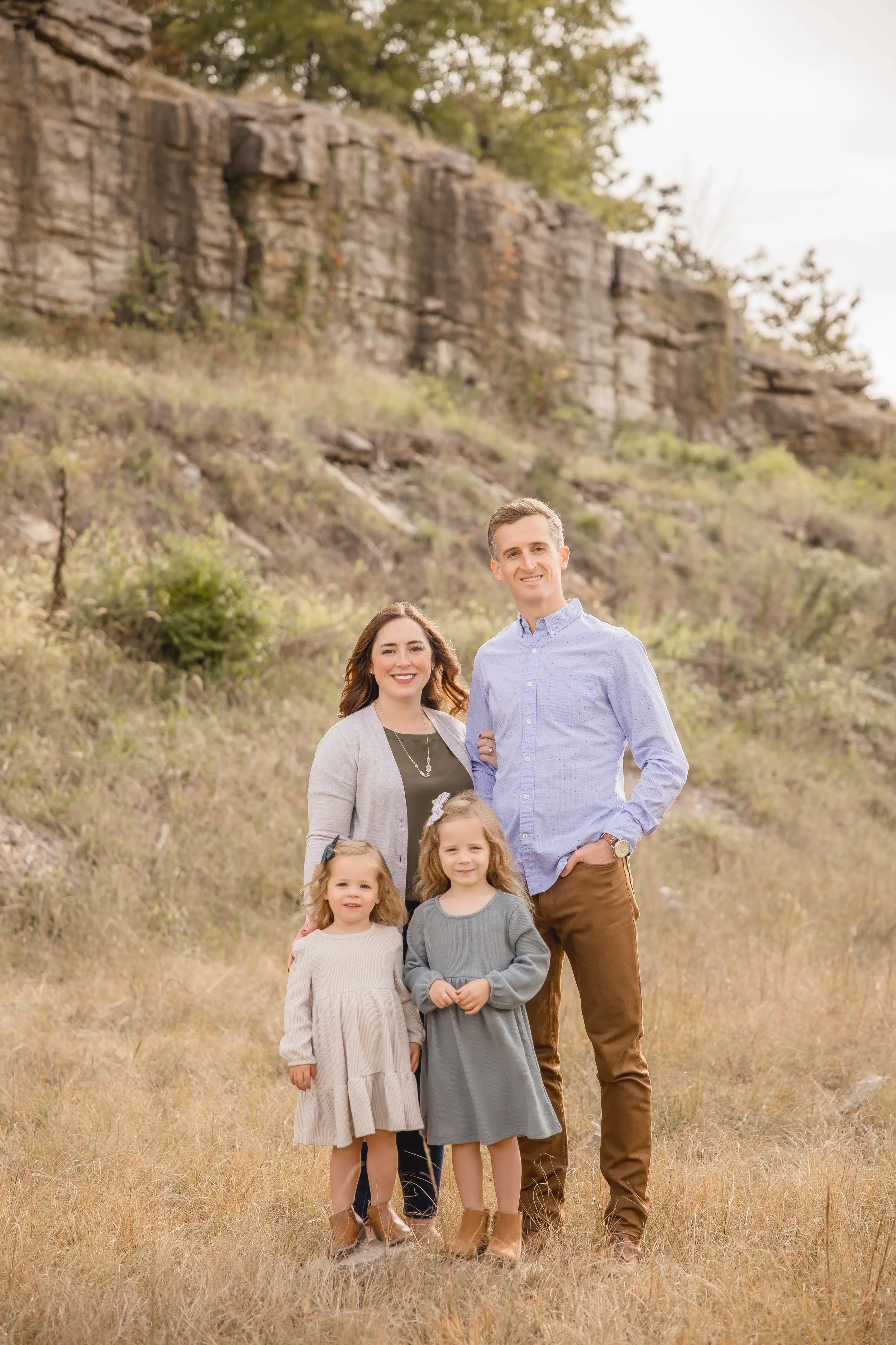 Kansas City family photography session at James A. Reed Memorial Wildlife Area with parents and two young daughters in a natural field setting