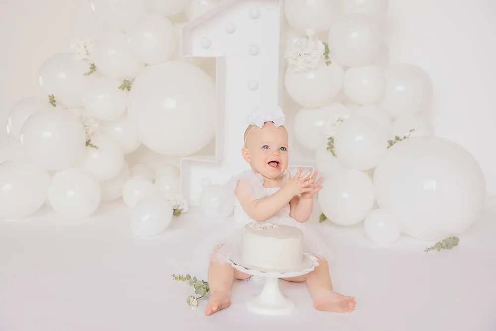 Kansas City first birthday photography session documenting baby’s one year milestone in a clean, neutral studio setting.