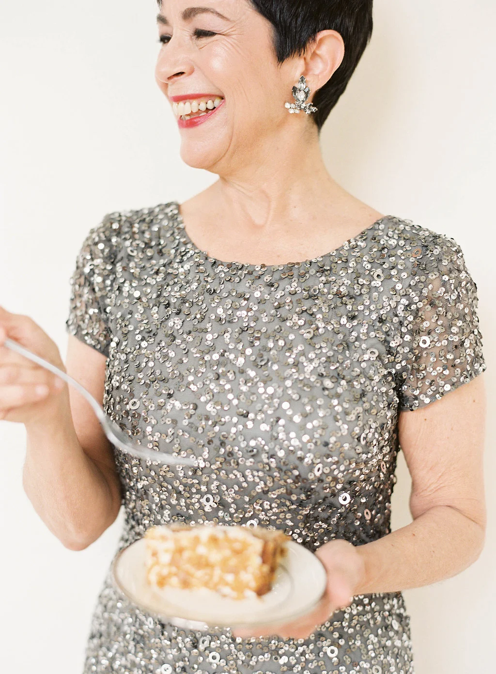 Copy of Mom eating cake in Adrianna Papell crunchy bead gown in lead silver sequin