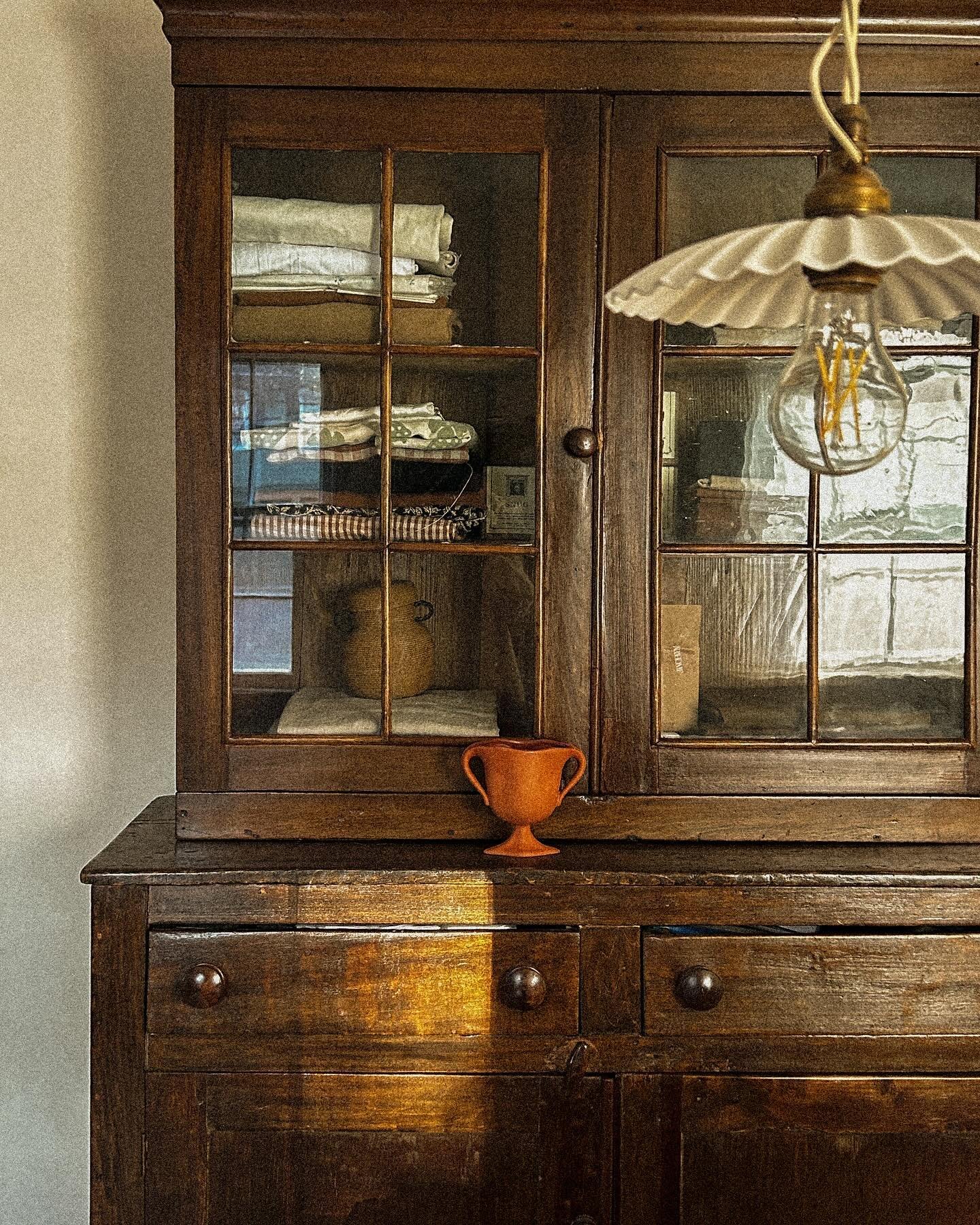 An antique cabinet, wavy glass and all. I think a room always needs something aged to ground it and add depth. Though it&rsquo;s old (guessing mid 1800s?) and wonky, it still functions remarkably well and is not too precious to be a workhorse in my o