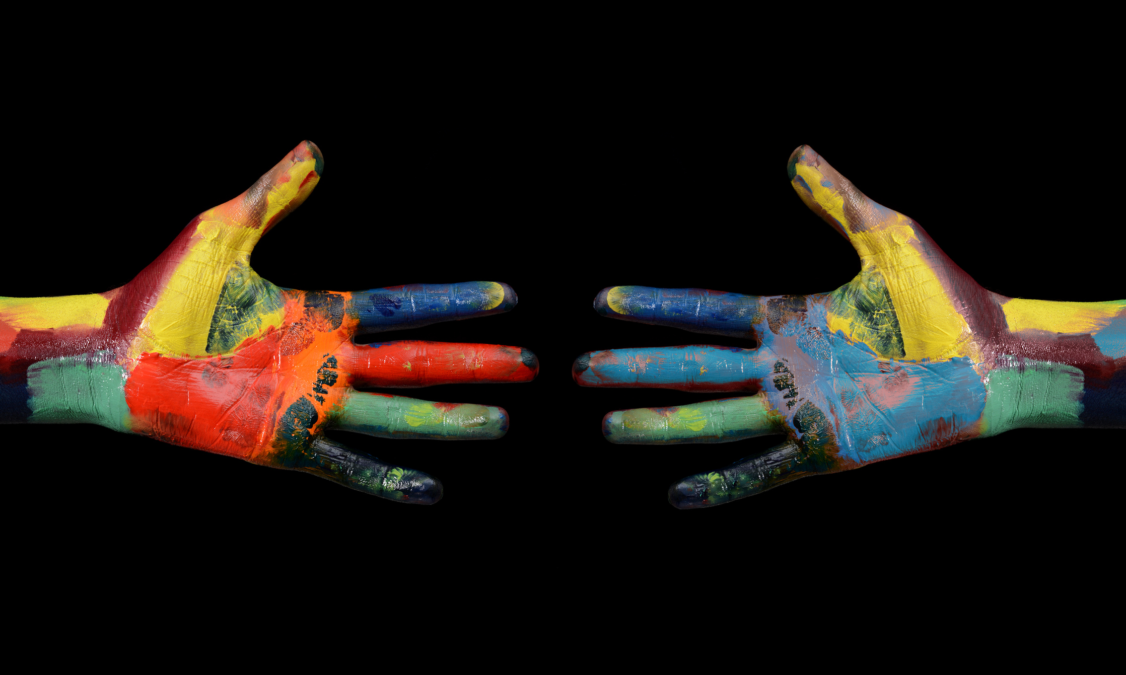 Two-Multi-Color-painted-hands-coming-to-each-other-607462436_2239x1343.jpeg