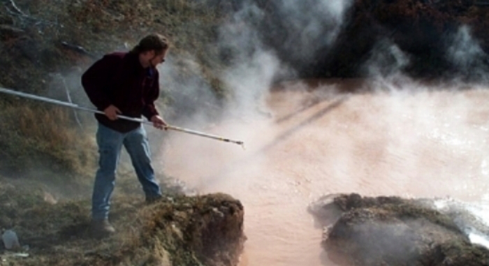 Dr. Stedman sampling Sulfolobus in the Rabbit Creek Hot Spring Area in Yellowstone National Park, United States, 2001