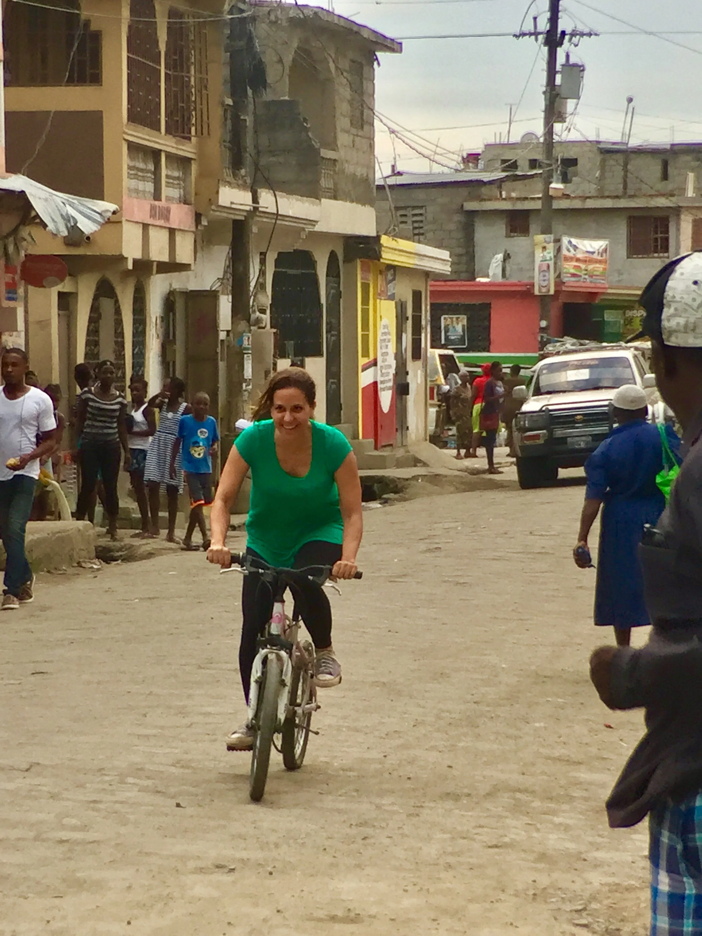 Jennifer riding bikes with the kids in Haiti