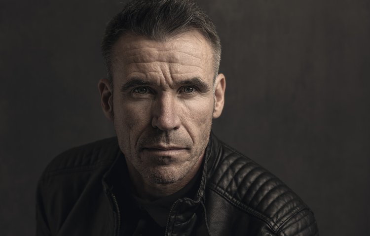 Man in a black leather jacket, studio portrait