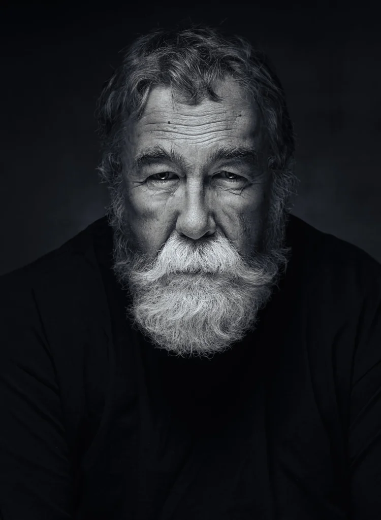 Black and white portrait of an older man with a white beard