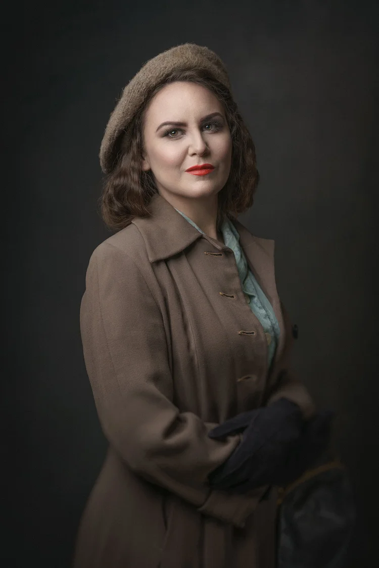 Woman in a 1940s-style beret and coat, painterly studio portrait