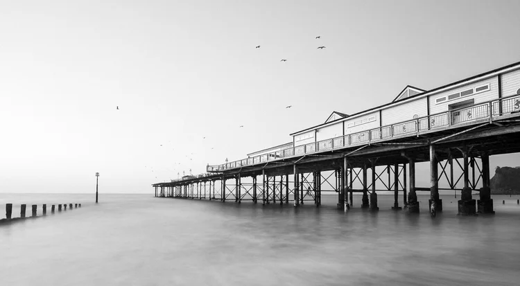 Black and white long exposure of Teignmouth Pier in a calm sea