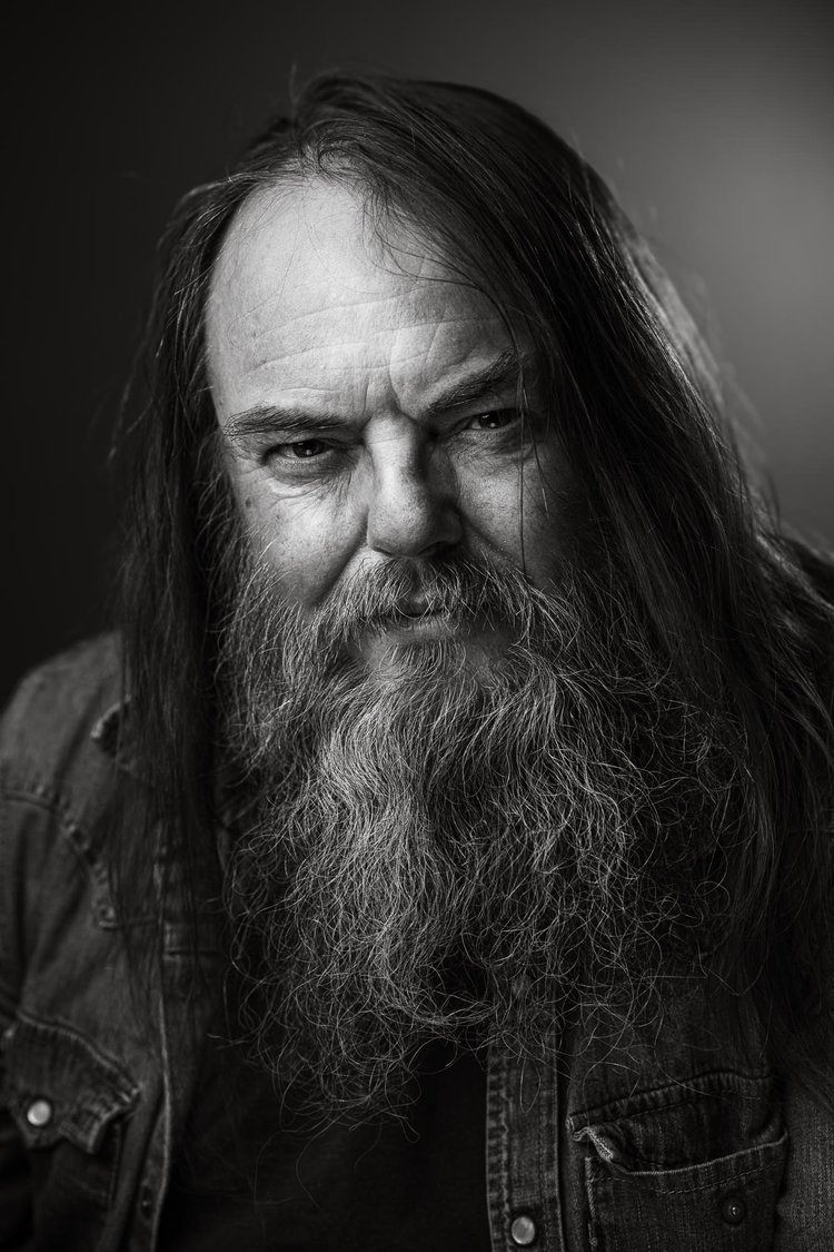 Black and white portrait of a man with long hair and a long grey beard