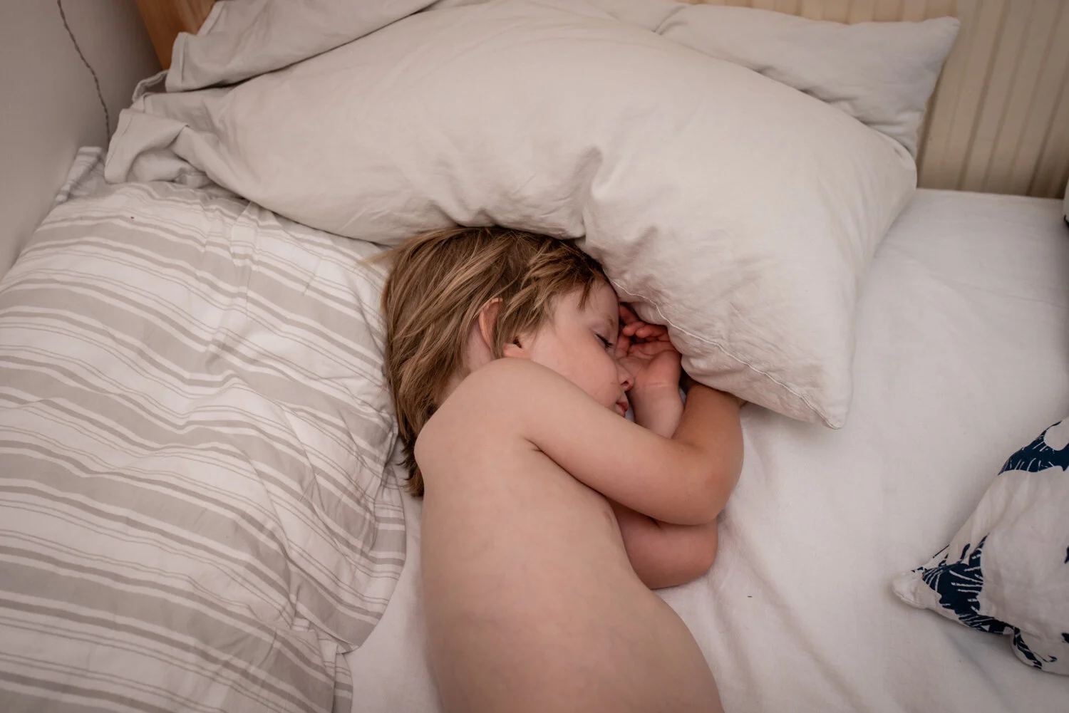 A three year old boy lies in his new bed fast asleep at his home in bath somerset.