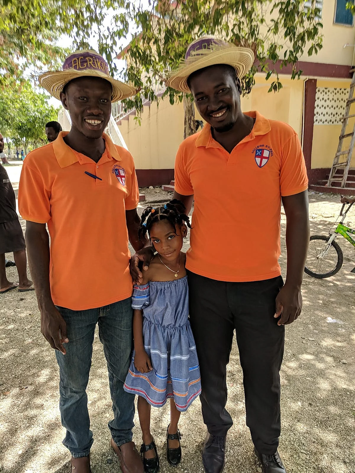 Agronomist Raphael (right) stands with Vladimy (left) and a young Harvest Fest attendee. Raphael gave the keynote speech of the Harvest Fest, and Vladimy, the entrepreneurship teacher at Paul’s School, emceed the event.