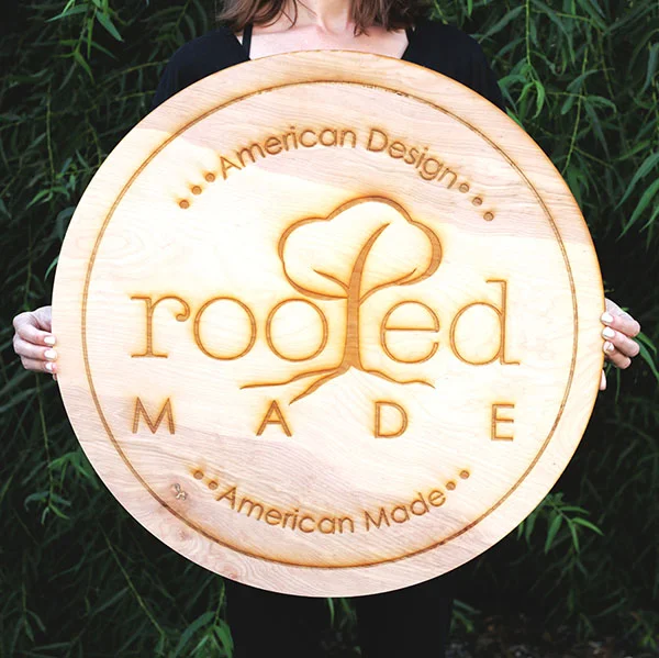 A hand crafted circle wood business sign, for hanging on the store wall.
