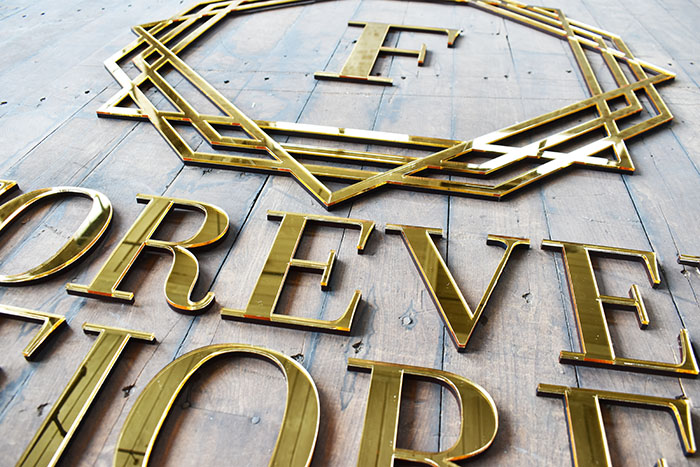 Detail of mirror lettering we laser cut for a small business in Florida.
