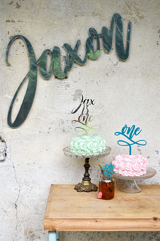 We hope these quick shots of our laser cut mirror name sign, first birthday cake toppers, and first birthday drink stirrers will inspire you for your birthday party planning!