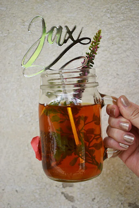 A silver "Jax" name drink stirrer made from mirror acrylic, so cool!