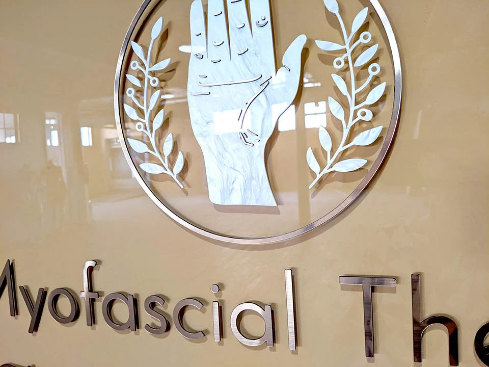 Detail of a custom laser cut sign we made for a massage therapy business.