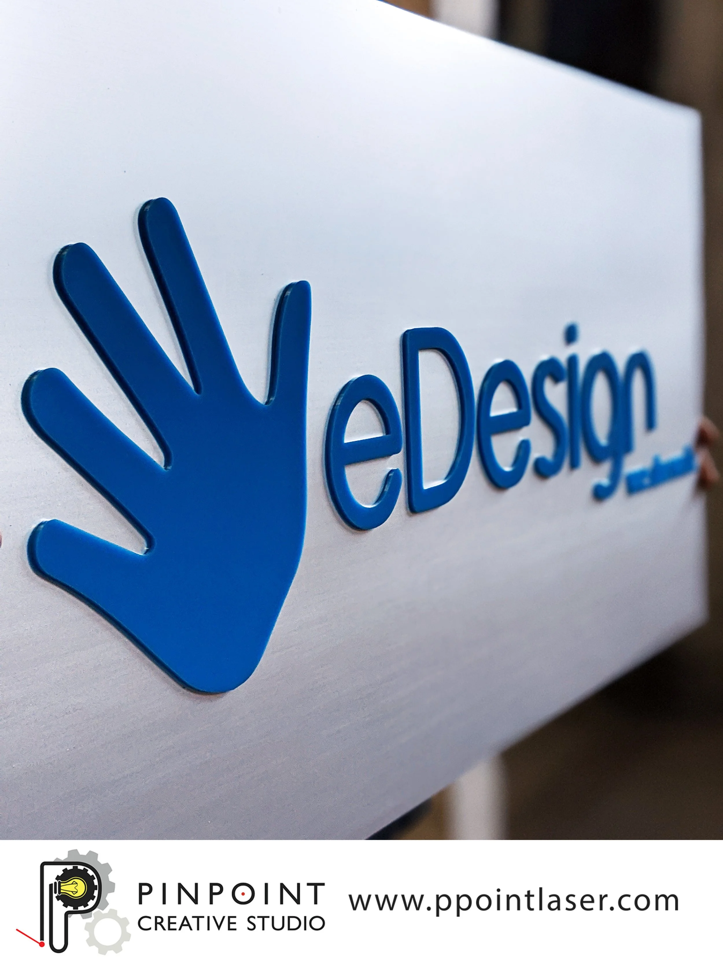 Custom boutique business sign made from blue acrylic mounted to 