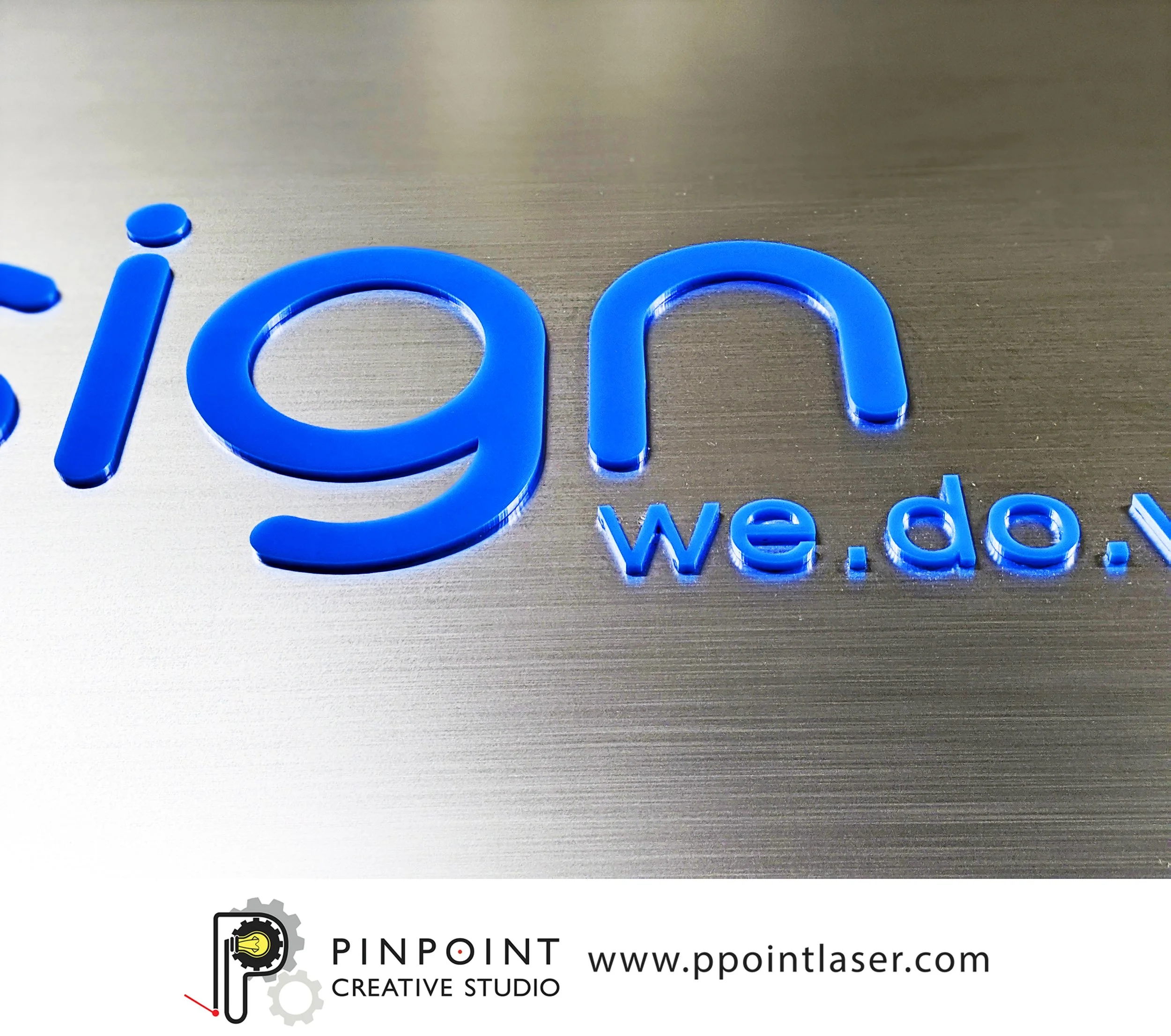 Custom boutique business sign made from blue acrylic mounted to 