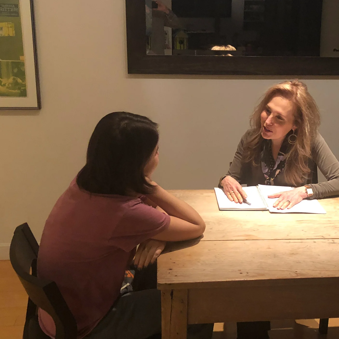 Jill works with a teen in her home, making plans for the summer.