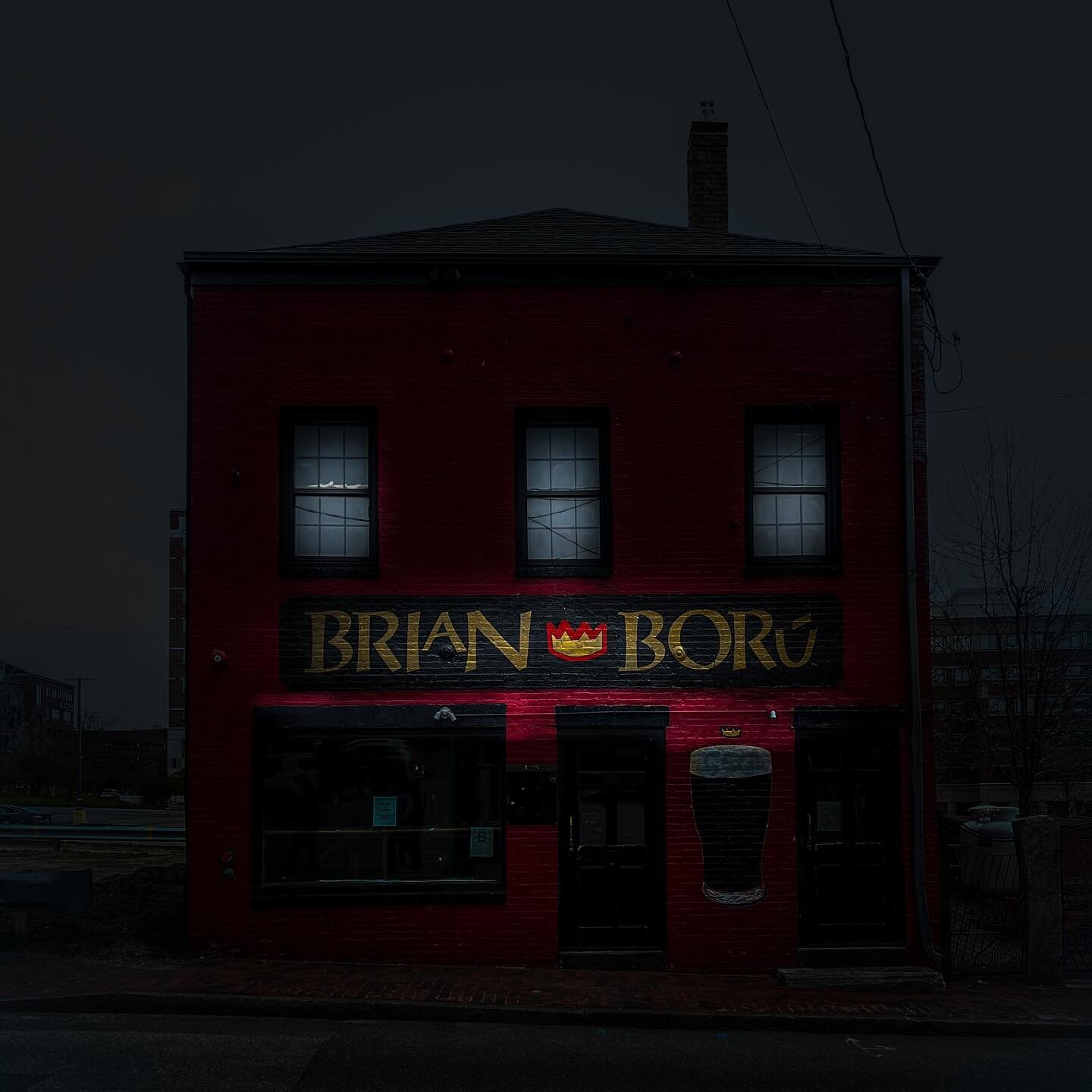 Under the cloak of night, the storied doors of Brian Bor&uacute; stand silent and steadfast, whispering tales of laughter and camaraderie that once echoed within its walls. This shot captures more than just a closed pub; it encapsulates a moment of t