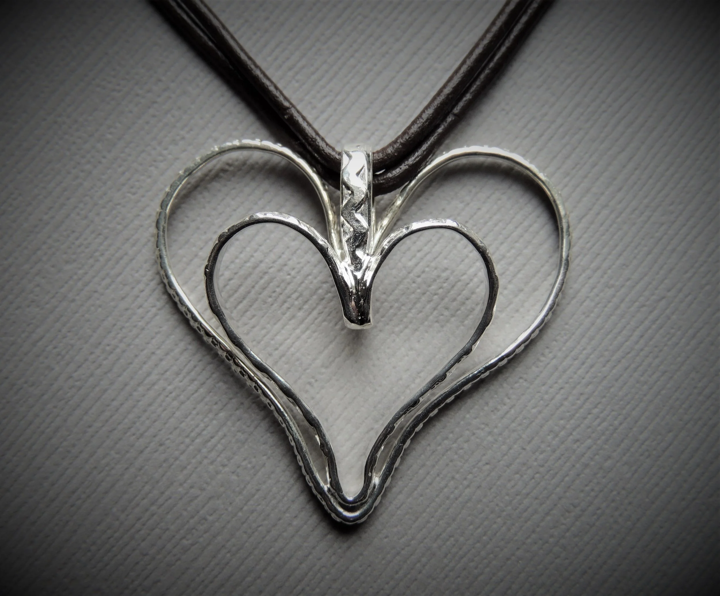 Sterling silver heart pendant with 18" long 2 mm brown leather cord