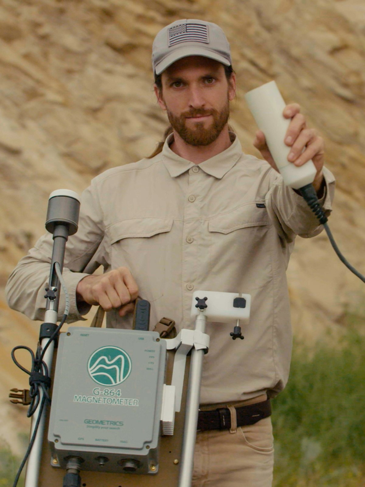 Stefan Burns holding a magnetometer in Utah 2021