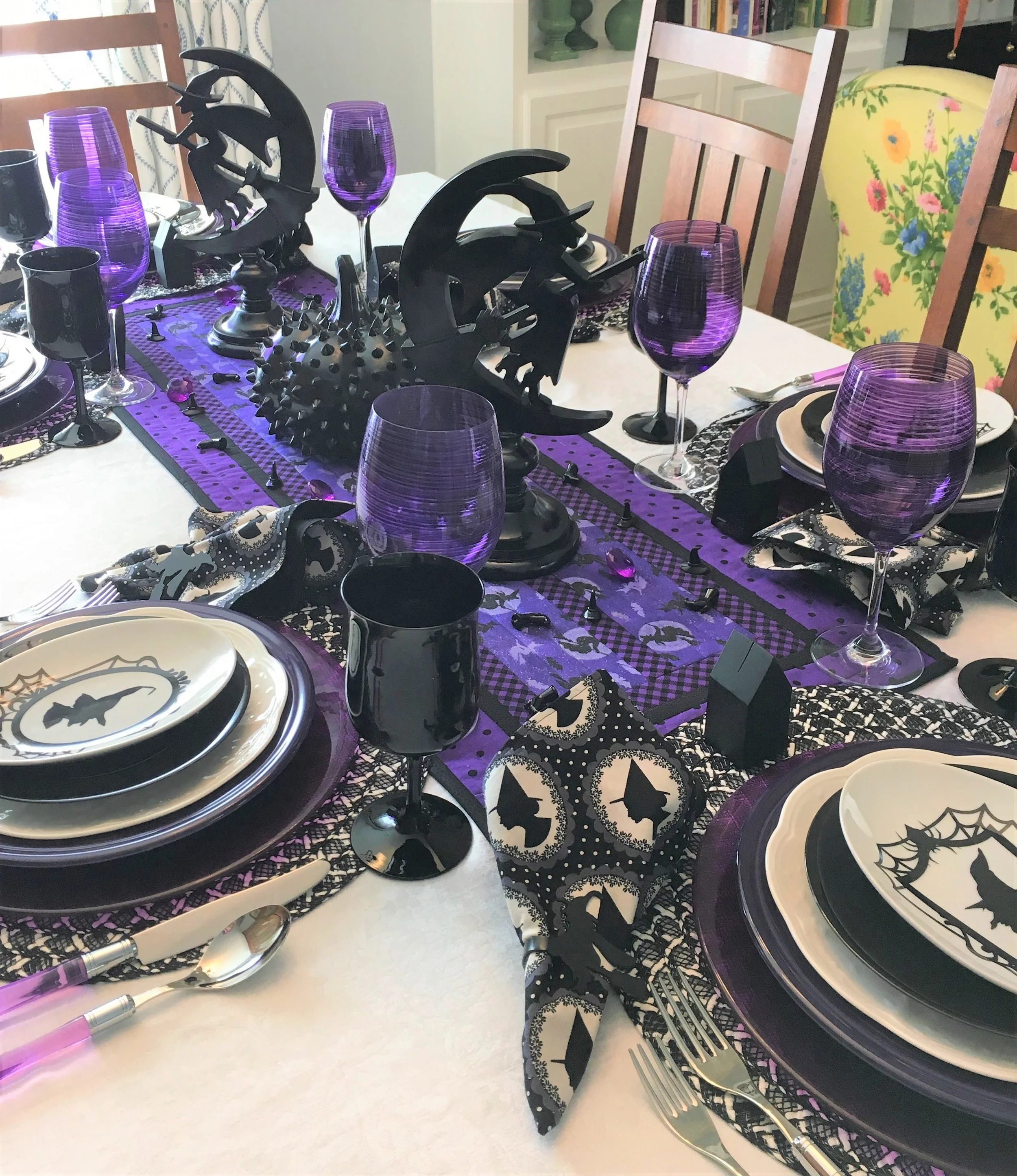 For a change I did a purple, black, and white table this year for Halloween. I picked the theme black witches last year and started gathering what I needed. The table runner was made by someone on Etsy and the colors worked perfectly for what I wanted to do. I also got the napkins on Etsy as well as the witch napkin rings. I saw a witch design I liked and asked if they could make napkin rings, I really love the way they turned out.