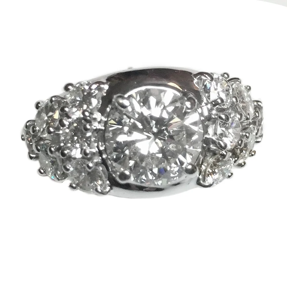 I redesigned a customer’s engament ring surrounding it with 12 of her diamonds and created this new wedding band. Much to my surprise one of my clients brought me a book of queen Elizabeth’s jewels. In it her engament ring had large center stone surrounded by 12 smaller ones in the same pattern. I was amazed that it was the same pattern although i had never seen it prior.