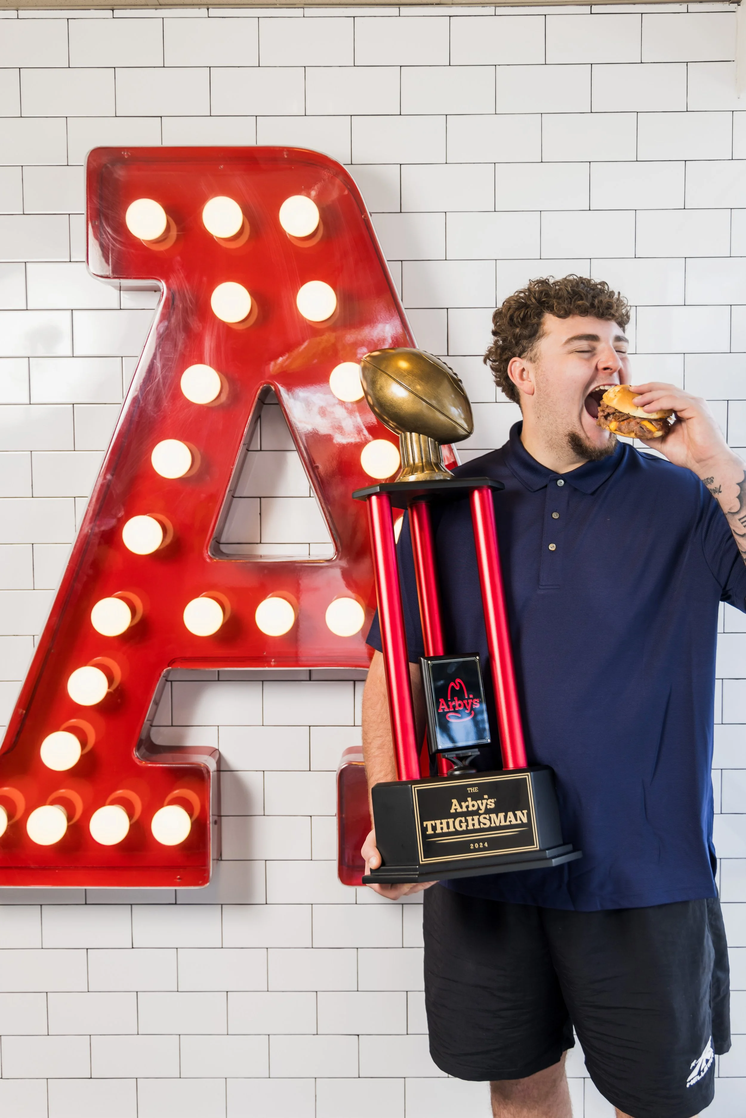 Mason Graham poses with the Arby's Thighsman Award at a local Arby's